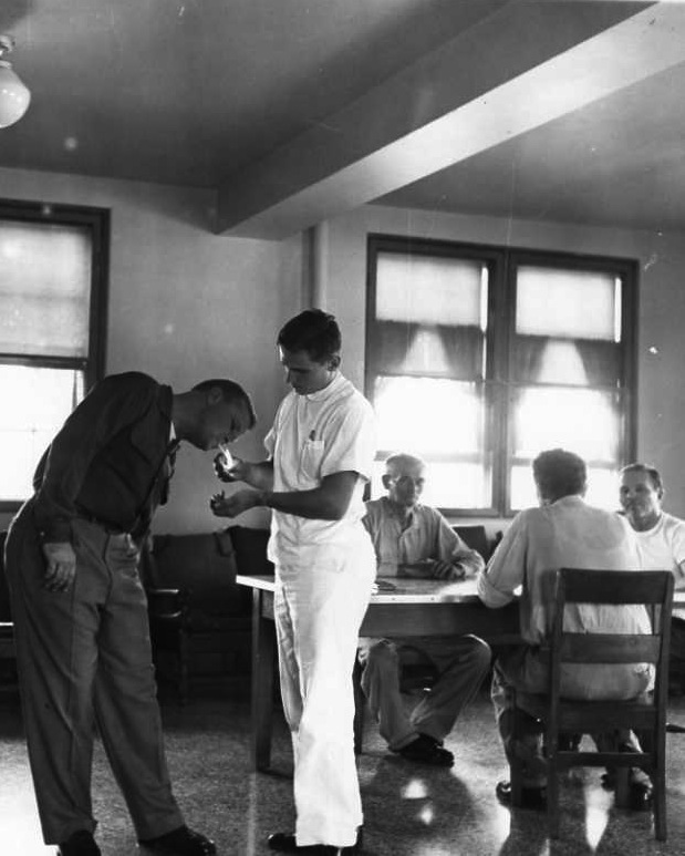 Hospital Attendant Lights a Cigarette for Patient Bus Bergen