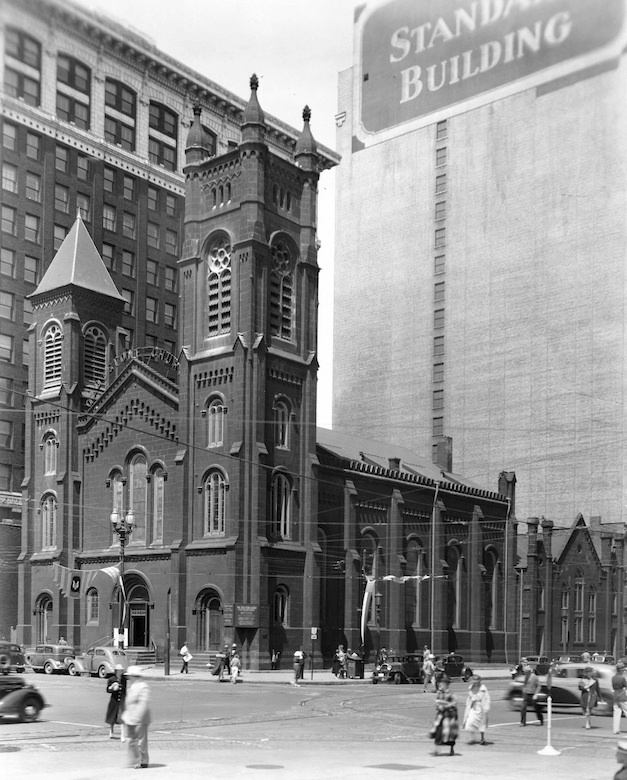 Pedestrians and Old Stone Church