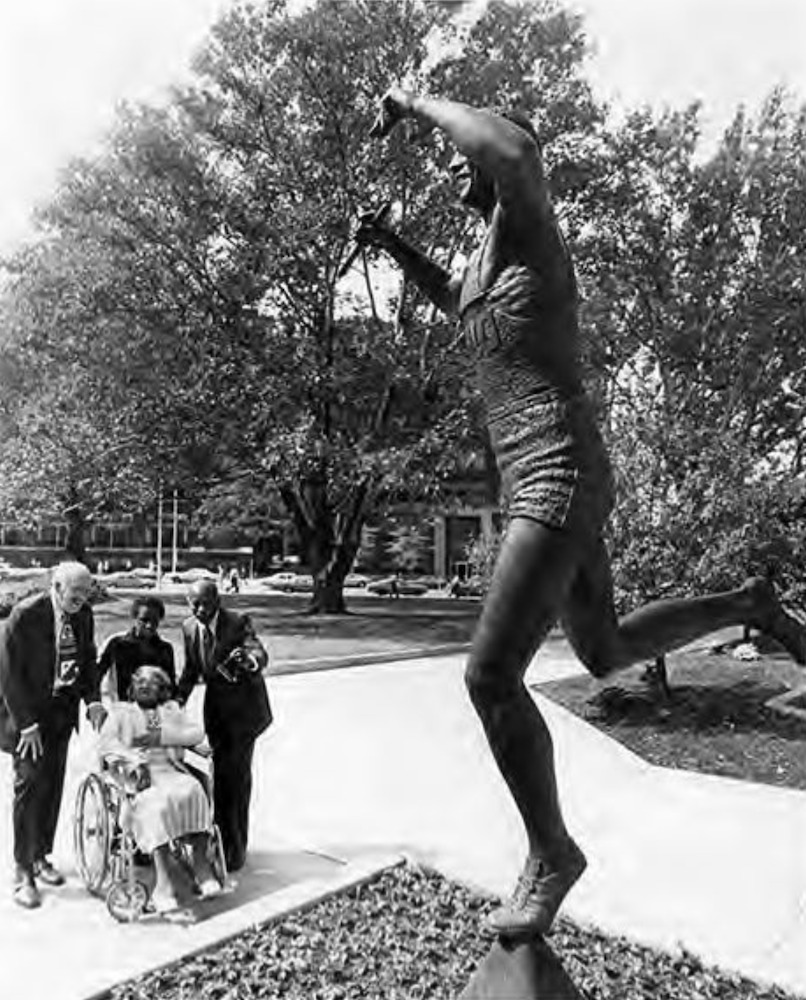 A sister visits her late brother's statue