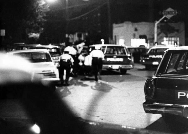 Policemen duck for cover during the Glenville Shootout
