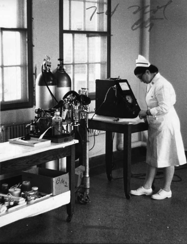 Nurse Inspecting an Electroshock Machine